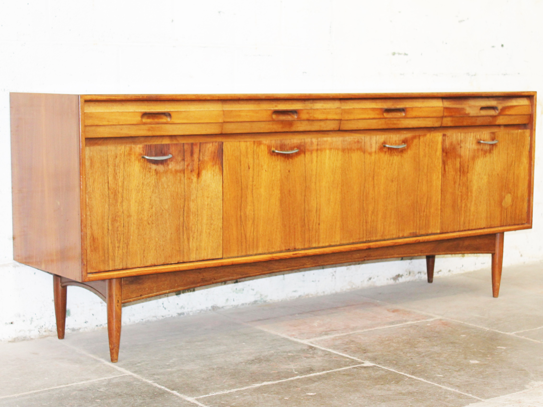 A teak and rosewood sideboard circa 1960. W187cm D47cm H77cm