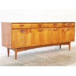 A teak and rosewood sideboard circa 1960. W187cm D47cm H77cm