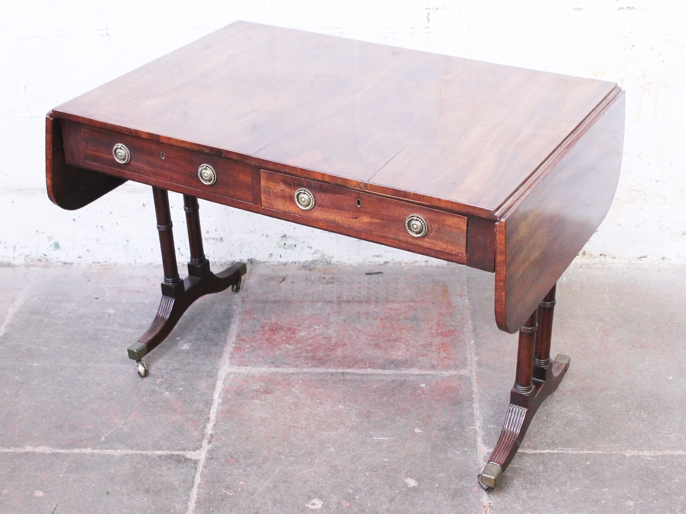 A Regency mahogany sofa table. W103cm D69cm H73cm