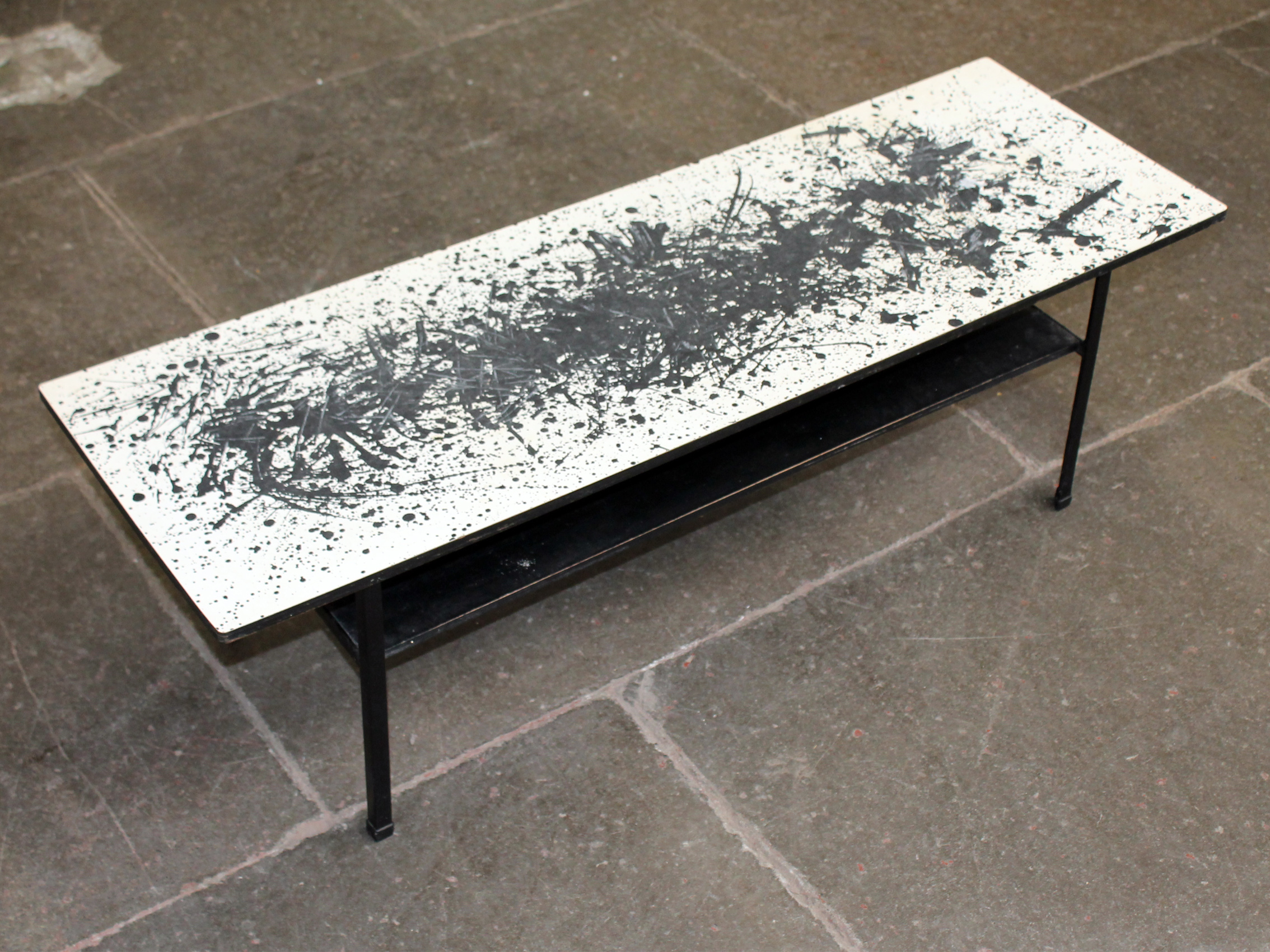 A vintage coffee table decorated in the manner of Jackson Pollock. L114cm