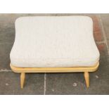 An Ercol light beech ottoman. L69cm