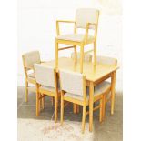 A Gordon Russell light oak extending table and six chairs circa 1950s. Labelled "Russell of