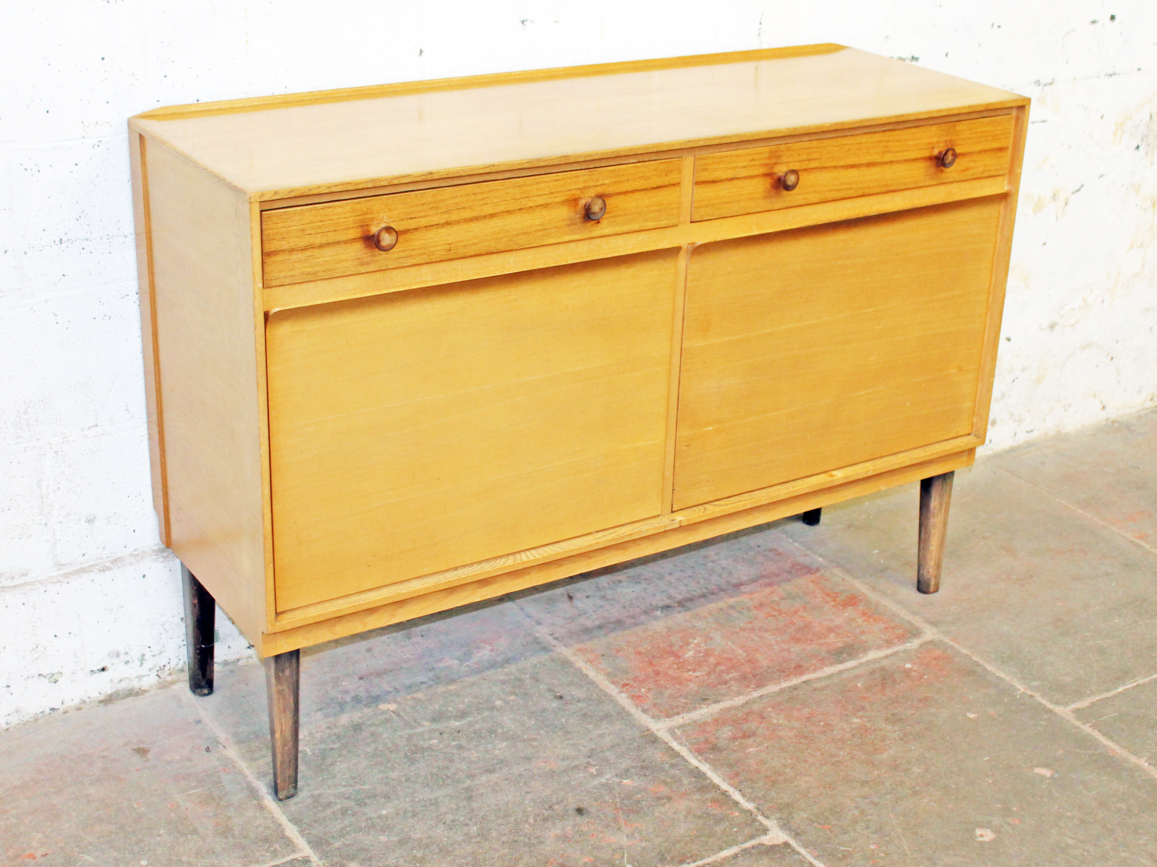 A Gordon Russell light oak sideboard circa 1950s. Labelled "Russell of Broadway". L137cm D46cm