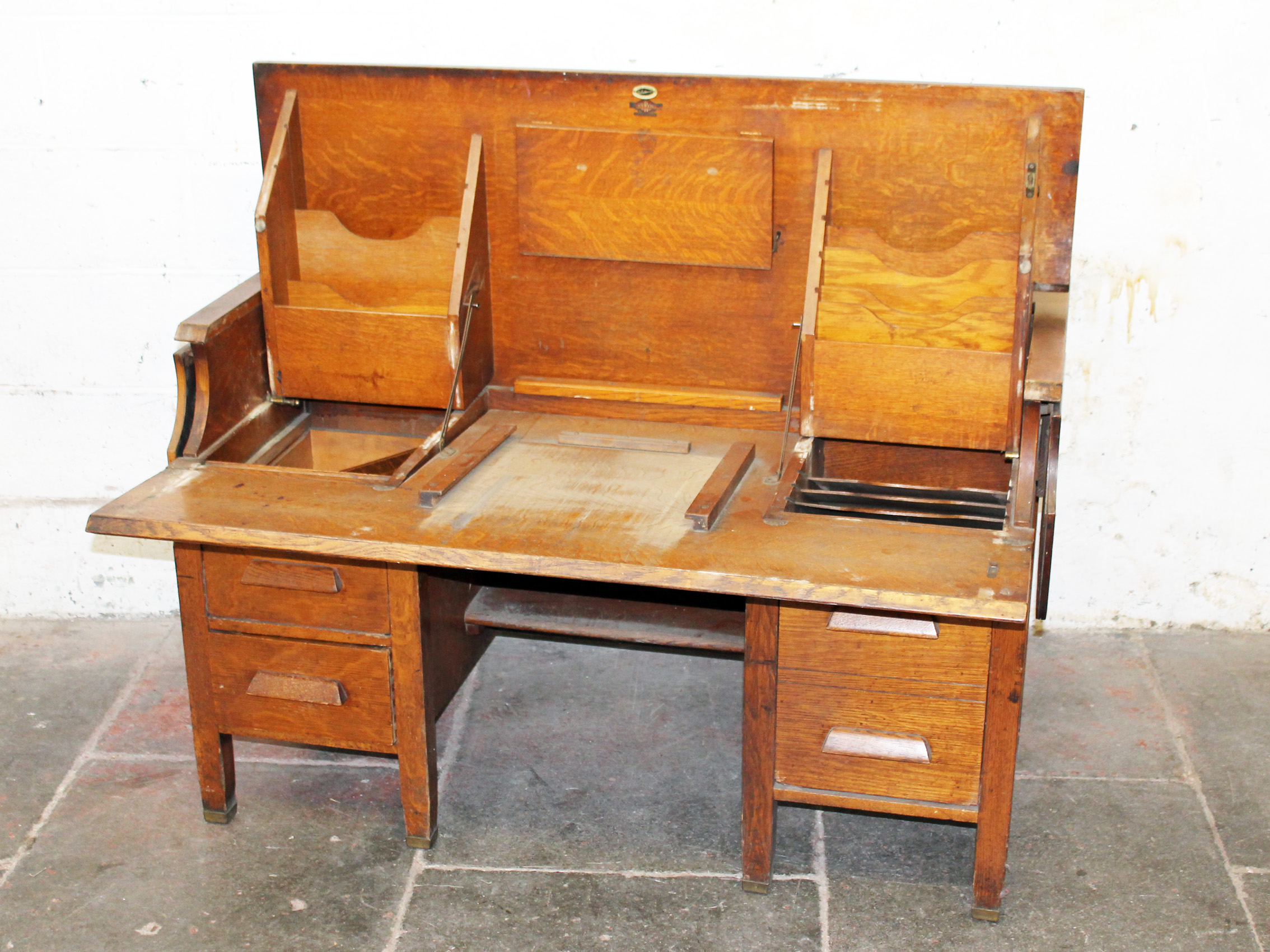 An oak fold out office desk labelled "Byron Louisville". W127cm D85cm H79cm