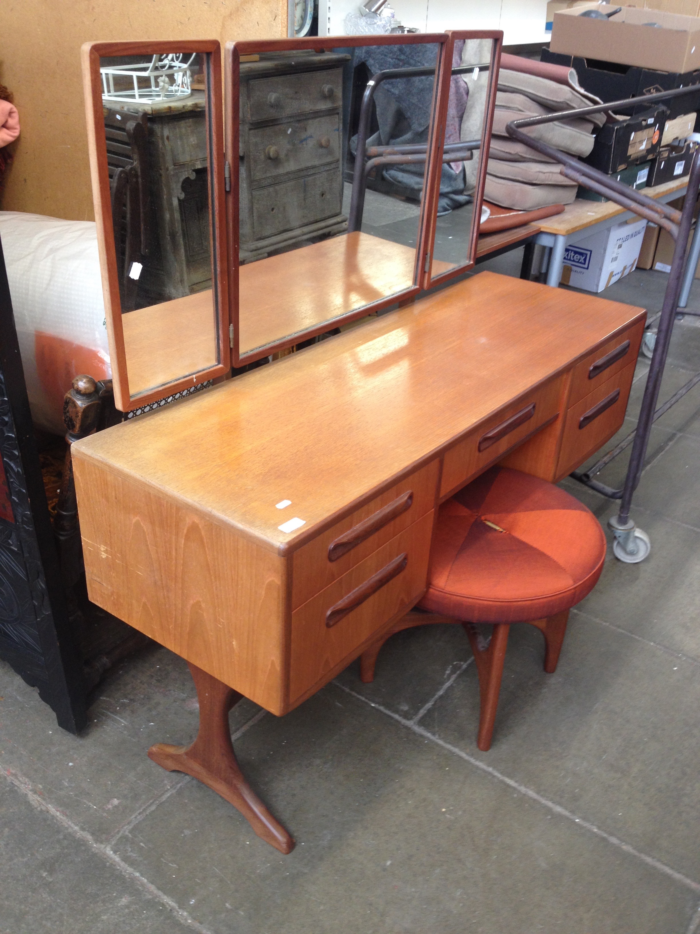 A G-Plan teak dressing table and stool. L137cm