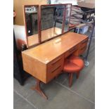 A G-Plan teak dressing table and stool. L137cm