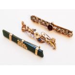 A group of three 9ct gold brooches comprising one jade, one set with seed pearls and another set