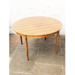 A Danish rosewood extending round dining table with two leaves possibly designed by Niels Moller.