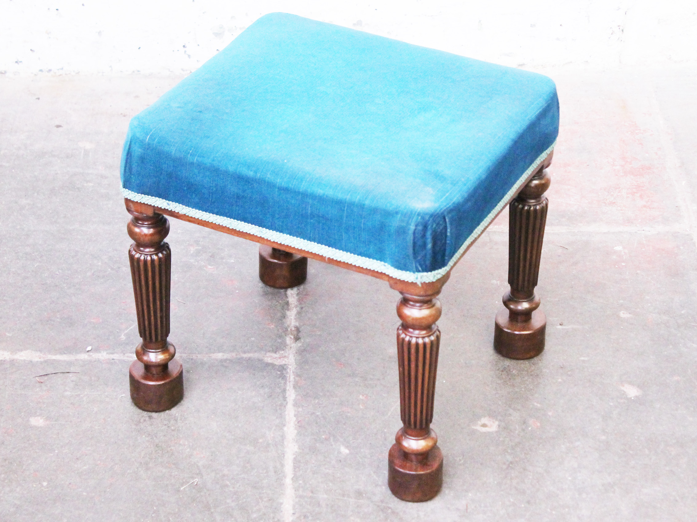 A Regency mahogany stool with reeded legs and later feet. H42cm