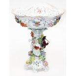 A Dresden porcelain pedestal bowl. H38cm. Condition - damage/repair to a couple of arms, chips to