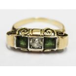 A 14ct gold three stone diamond and emerald ring