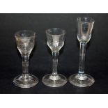 A "Jacobite" style etched drinking glass circa 1750 together with two other 18th Century glasses.