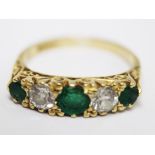 An 18ct gold diamond emerald ring. Gross wt. 3.2g. Size L