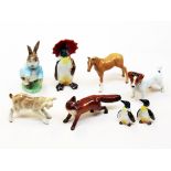 A group of eight Beswick animals comprising three penguins, two foals, a fox, a dog and a Beatrix