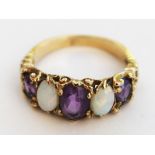 A 9ct gold opal and amethyst ring. Gross wt.3.4g. Size M