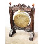 A 19th Century brass gong in carved oak frame. H107cm
