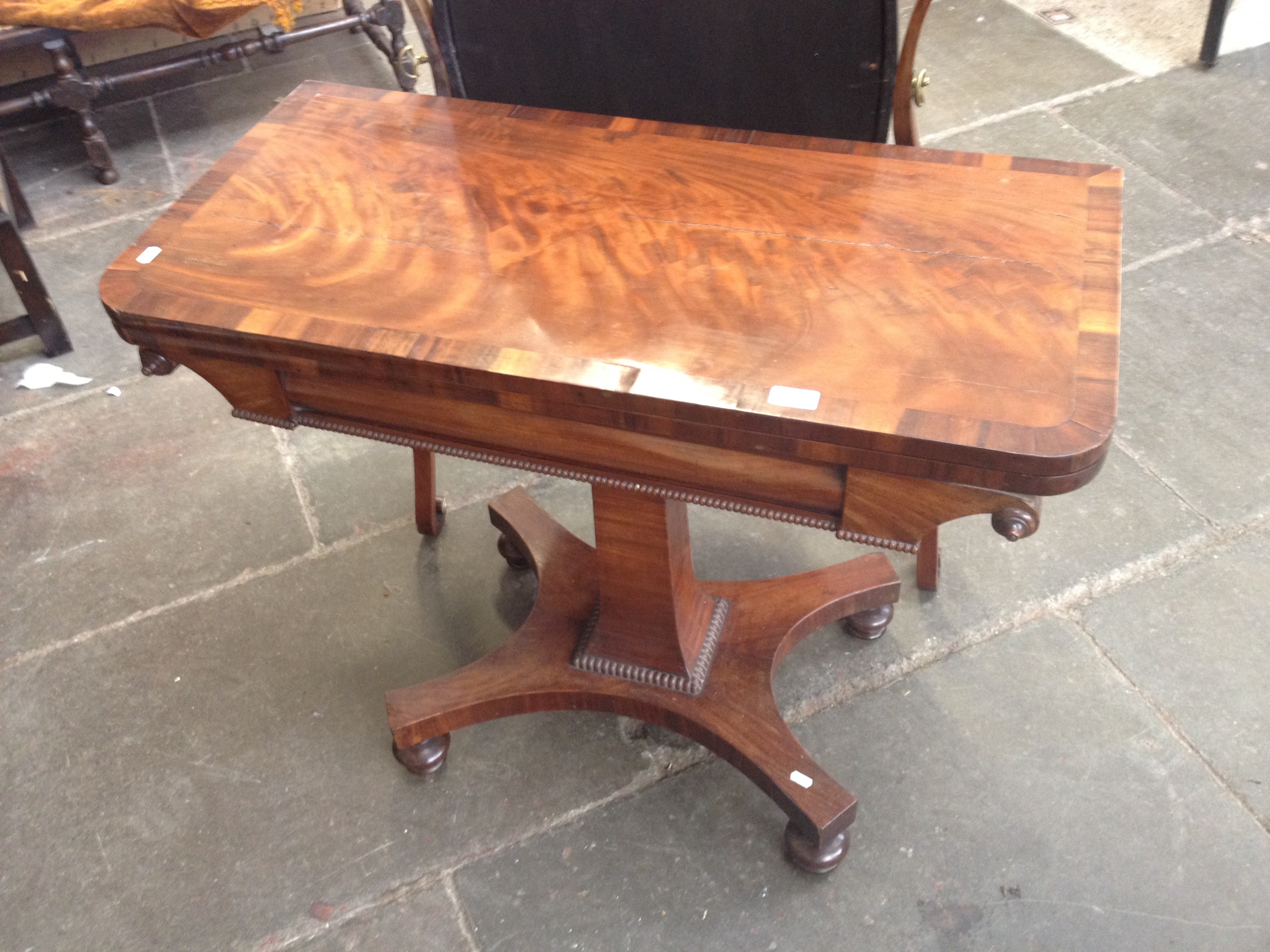 A cross banded mahogany card table