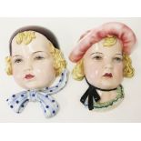 Two Goldscheider pottery wall masks. L24cm. Condition - girl with pink hat has been broken and