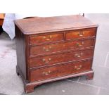 A George III oak chest of drawers with brass loop handles and bracket feet. W100cm D53cm H81cm