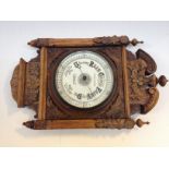 A carved oak framed barometer, the dial labelled Stoke & Watson Manchester. L48cm