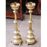 A pair of brass candle stands in the manner of Pugin. H81cm