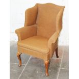 A Queen Anne style winged back armchair. H102cm