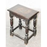 A 17th Century oak joined stool. H57cm