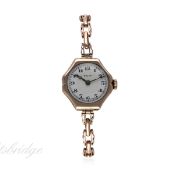 A LADIES 9CT SOLID ROSE GOLD ROLEX BRACELET WATCH CIRCA 1920s
D: White enamel dial with Arabic