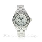 A LADIES MID SIZE WHITE CERAMIC & DIAMOND CHANEL J12 BRACELET WATCH DATED 2010, REF. H1628 WITH