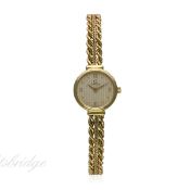 A LADIES 18K SOLID GOLD OMEGA BRACELET WATCH CIRCA 1980s
D: Silver dial with raised gilt Roman