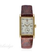 A GENTLEMAN'S 18K SOLID GOLD PATEK PHILIPPE RECTANGULAR WRIST WATCH CIRCA 1940s
D: Silver dial