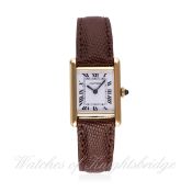 A LADIES 18K SOLID GOLD CARTIER TANK WRIST WATCH
CIRCA 1980s
D: White dial with Roman numerals &