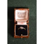 An 18ct gold ring set with three diamond