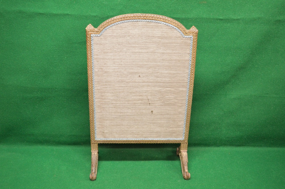 A carved framed fire screen having arche