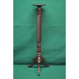 A mahogany torchere having circular top