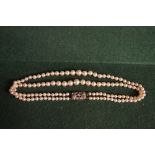 A pearl necklace with silver clasp