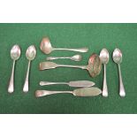 Seven pieces of silver flatware together