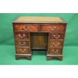 A 20th century mahogany desk having tan