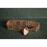 A 9ct gold gate bracelet with heart clas