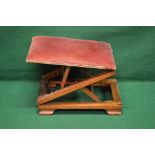 An oak framed adjustable gout stool with