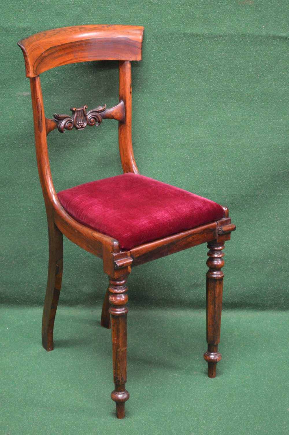 A rosewood cellists chair having curved
