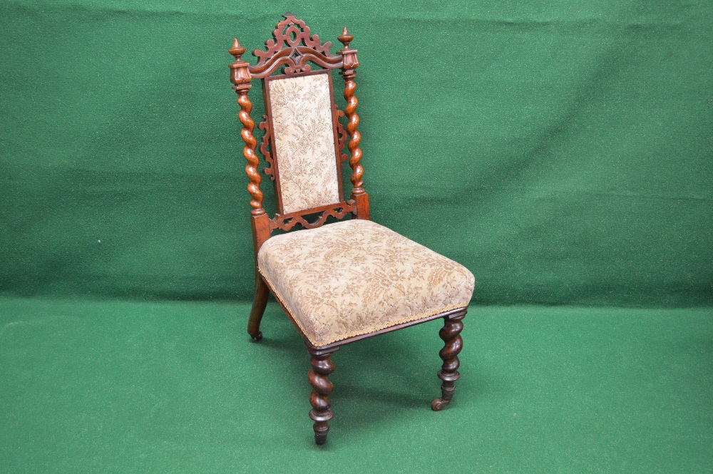 A Victorian rosewood nursing chair havin