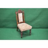 A Victorian rosewood nursing chair havin