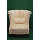 20th century barrel back armchair in cream upholstery with removable seat cushion and standing on