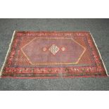 Red ground rug having green,