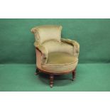 Victorian mahogany framed tub armchair with green upholstery and standing on turned front legs with