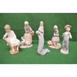 Group of six various Lladro figures to include one of a young boy seated on a tree stump