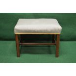 A mahogany dressing stool having over stuffed seat and standing on square moulded legs,