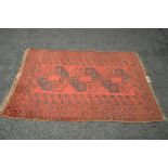 Red ground rug with black pattern with end tassels - 74" x 48"