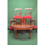 Victorian mahogany wind out dining table with extra leaf and standing on cabriole legs ending in